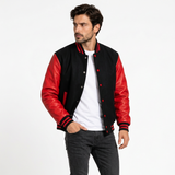 Male model in a standing editorial pose wearing the black-and-red varsity jacket